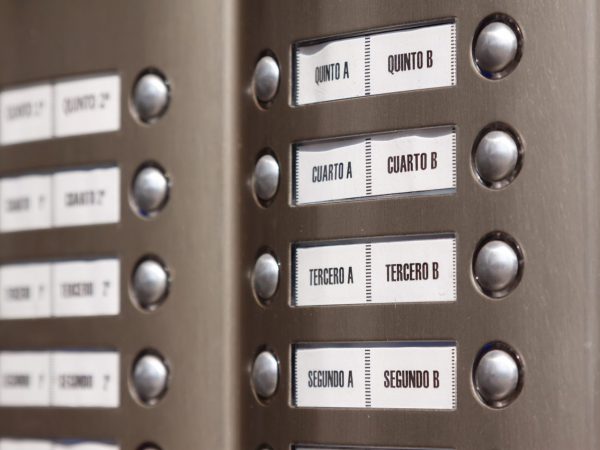 Close-up of building intercom. Numbers in Spanish